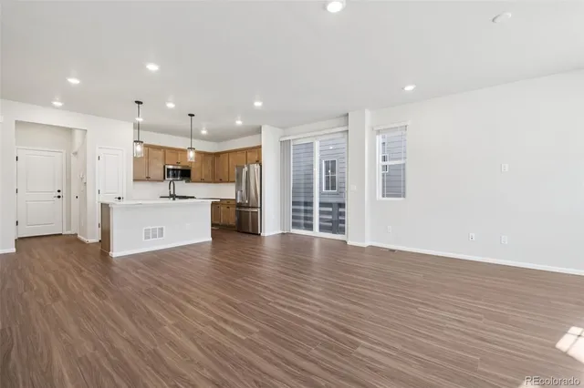 a view of kitchen with wooden floor and windows