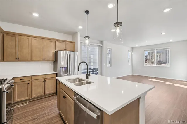 a kitchen with a sink cabinets and wooden floor