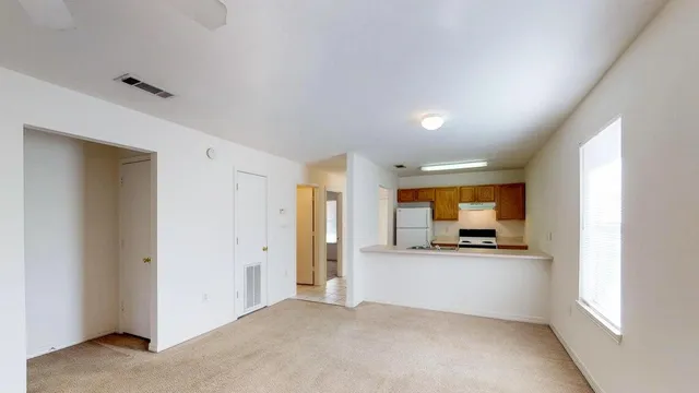 a view of a kitchen with a sink and a refrigerator