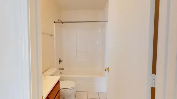 a bathroom with a tub and a toilet