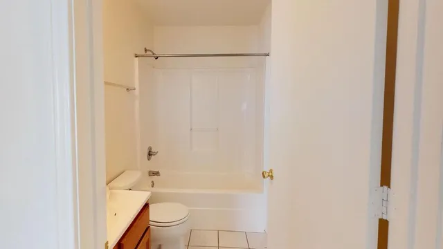 a bathroom with a tub and a toilet