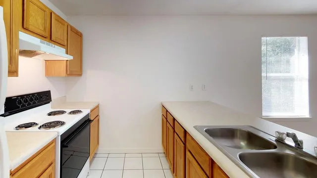 a kitchen that has a sink and a stove