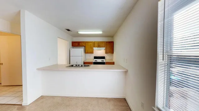 a view of a kitchen with a sink and a window