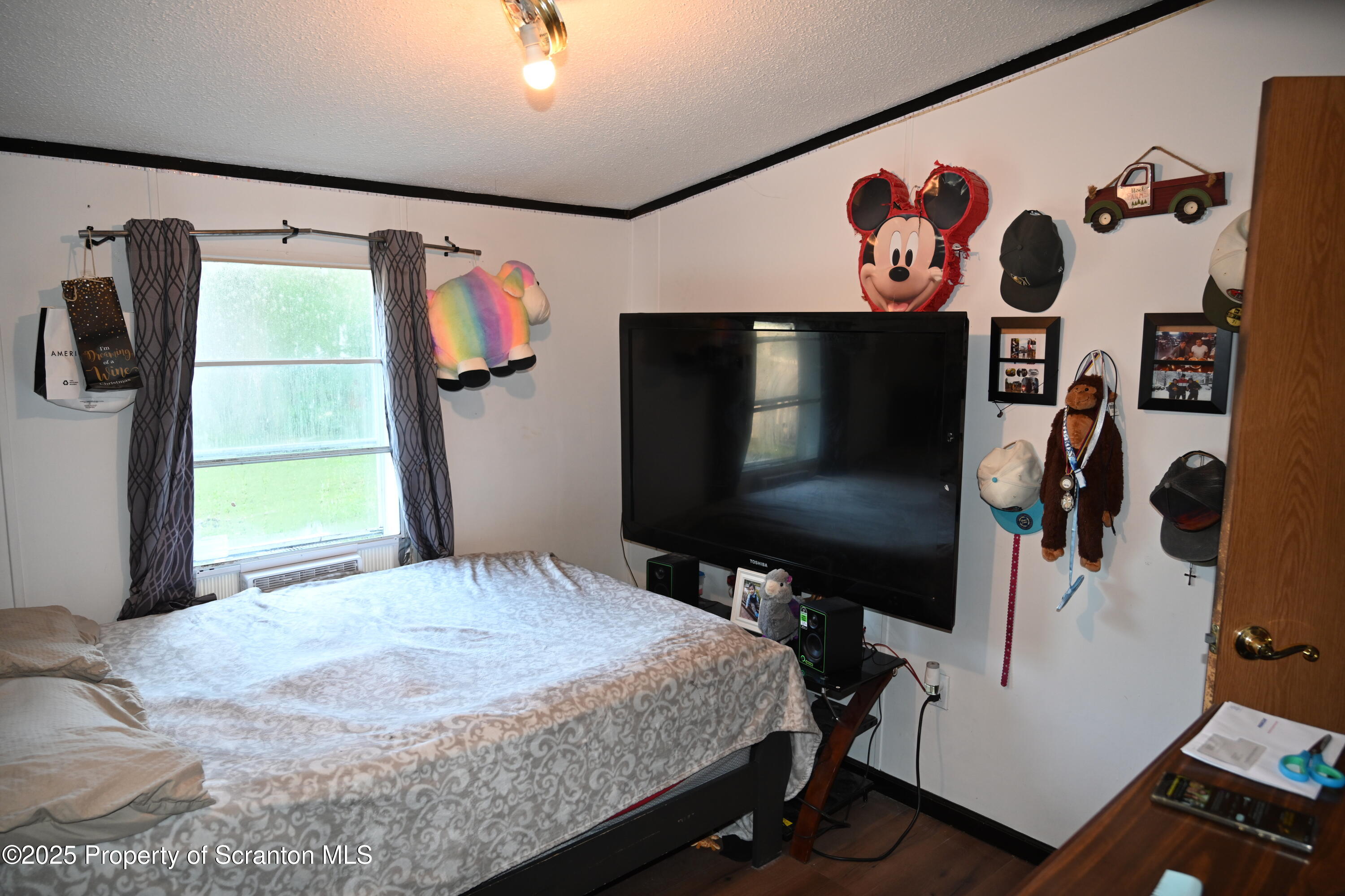 84 Spring Street Great Bend, PA 18821 - Photo 13 of 20 a bedroom with a bed and a flat screen tv