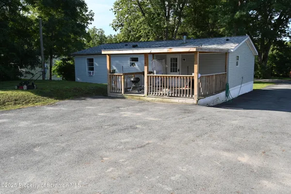 a view of a house with a yard and fence