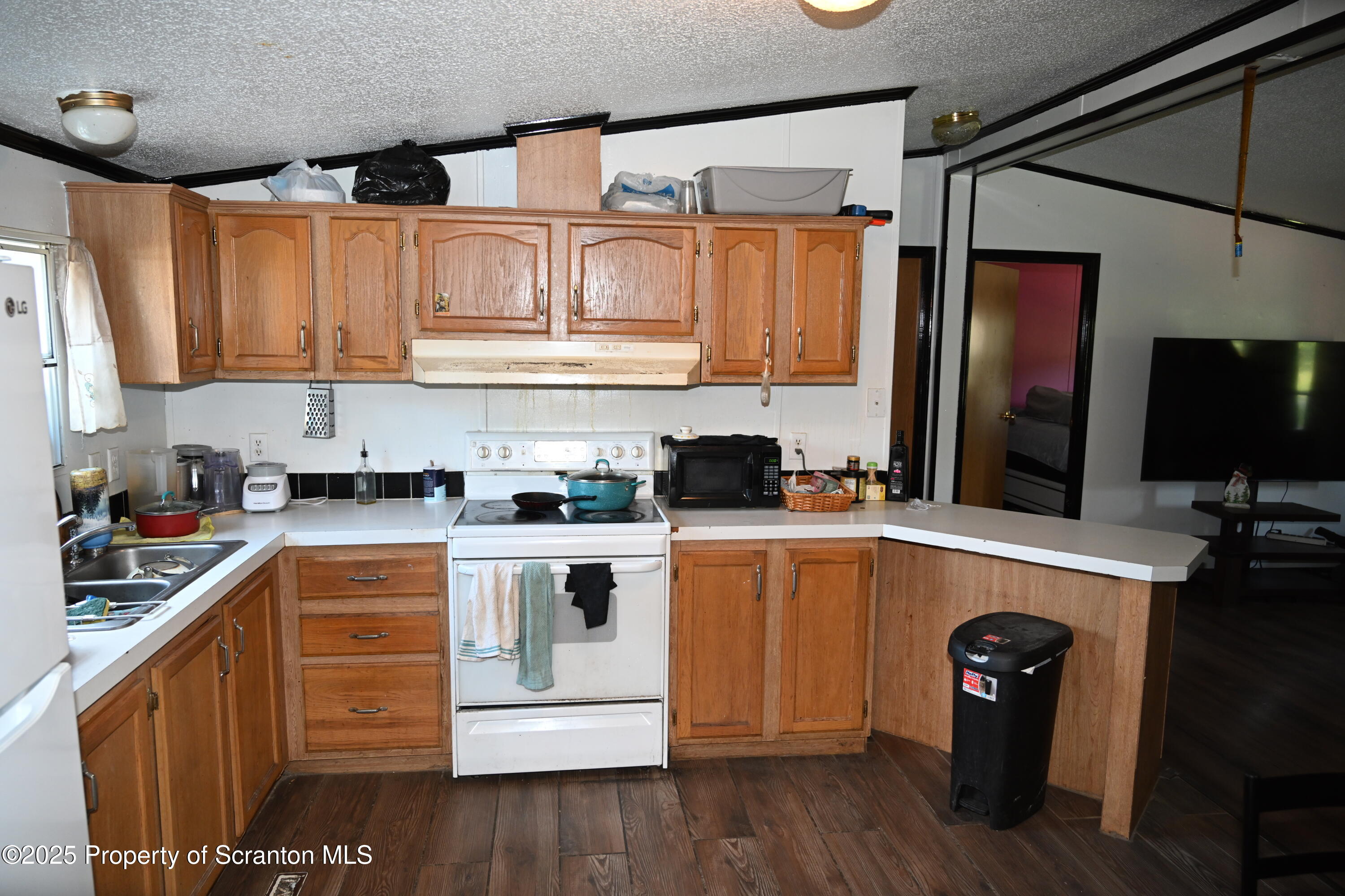 84 Spring Street Great Bend, PA 18821 - Photo 3 of 20 a kitchen with stainless steel appliances granite countertop a refrigerator and a stove top oven