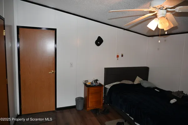 a bedroom with a bed and a potted plant