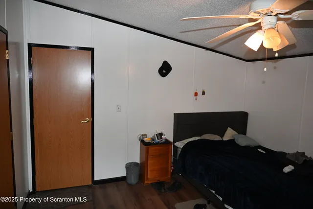 a bedroom with a bed and a potted plant