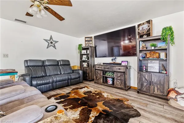 a living room with a couch and a chandelier