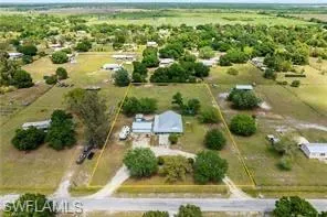an aerial view of residential houses with outdoor space and lake view
