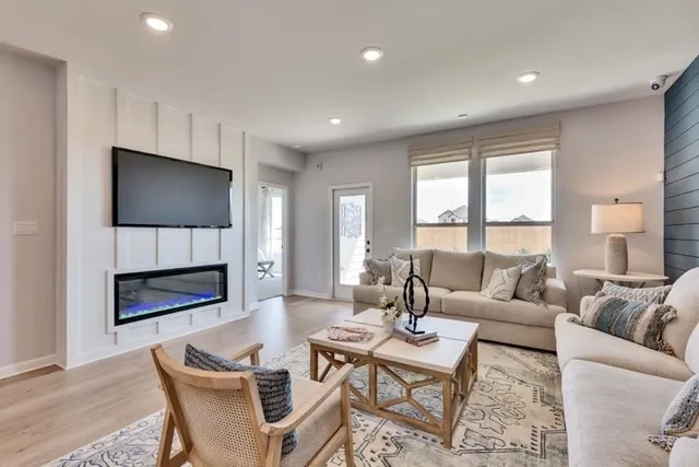 a living room with fireplace furniture and a flat screen tv
