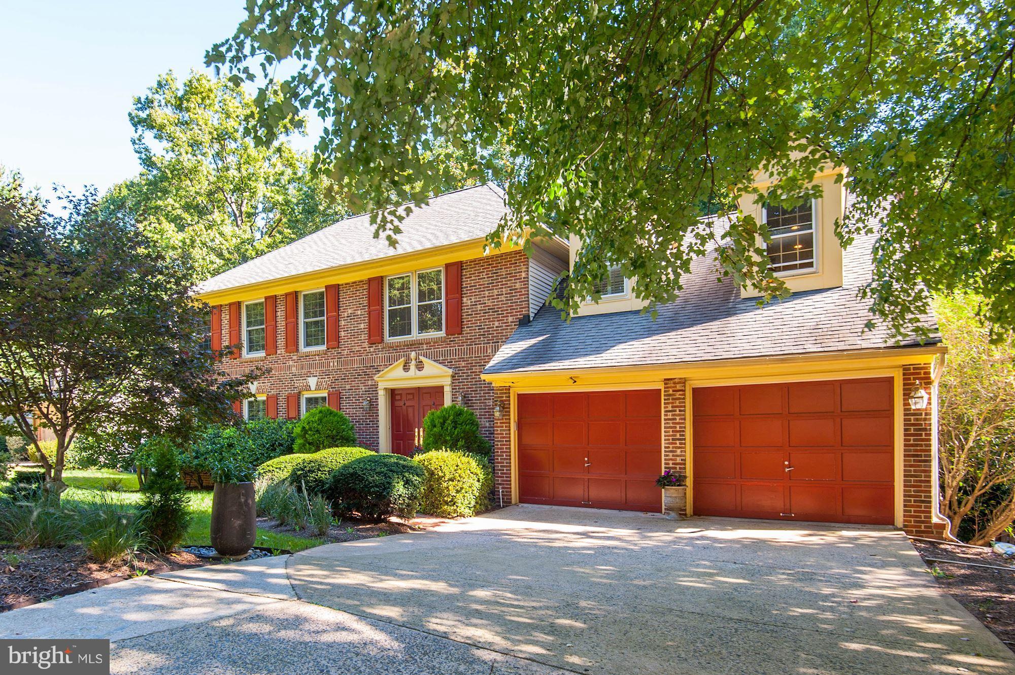 11680 Bennington Woods Road Reston, VA 20194 - Photo 1 of 1 a front view of a house with a garden