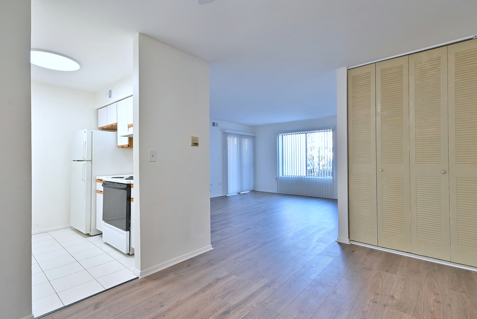6177 Knoll Wood Road, Unit 102 Willowbrook, IL 60527 - Photo 7 of 19 wooden floor in an empty room with a window