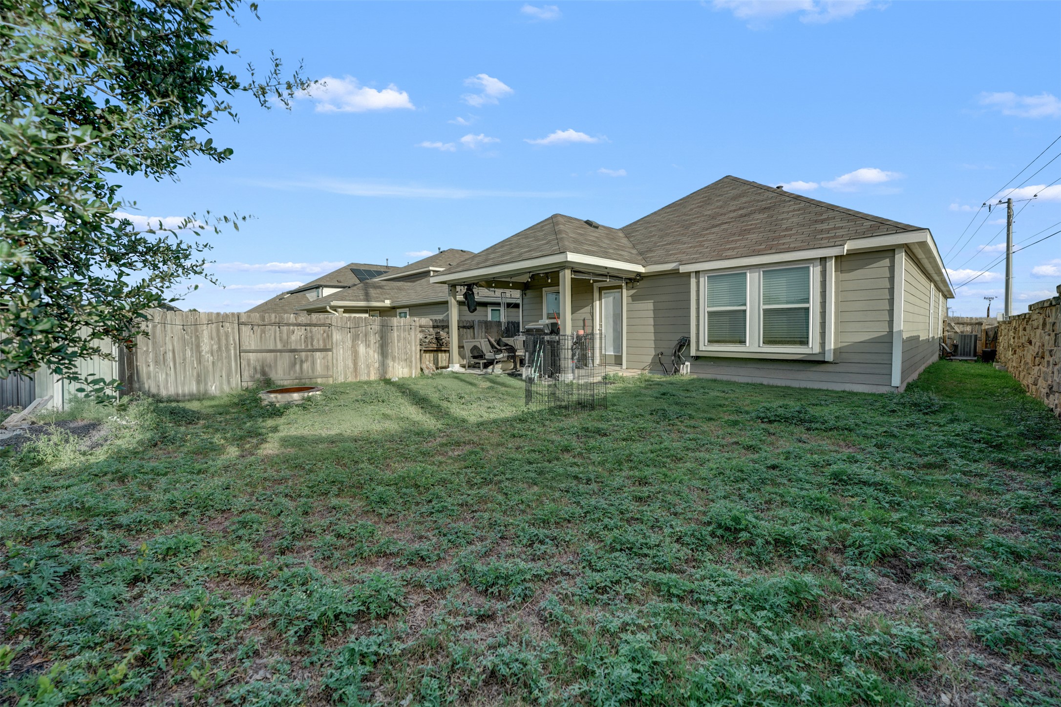 5806 Aviano Road Round Rock, TX 78665 - Photo 7 of 29 A spacious backyard with a private wooden fence and a charming covered patio for outdoor enjoyment.