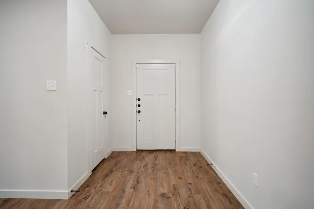 a view of a room with wooden floor