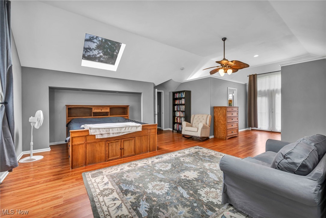 9083 Shepard Road Macedonia, OH 44056 - Photo 26 of 50 Bedroom with a skylight, light wood-style flooring, lofted ceiling, and a ceiling fan