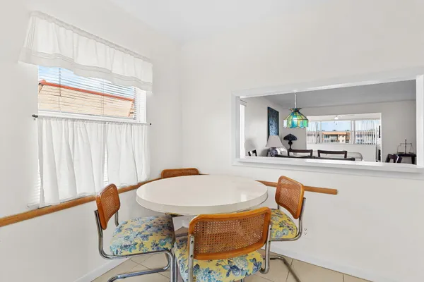 a dining room with furniture and window