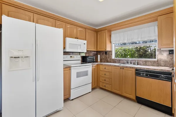 a kitchen with stainless steel appliances a refrigerator sink and cabinets