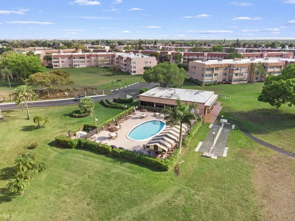 an aerial view of residential houses with outdoor space and river