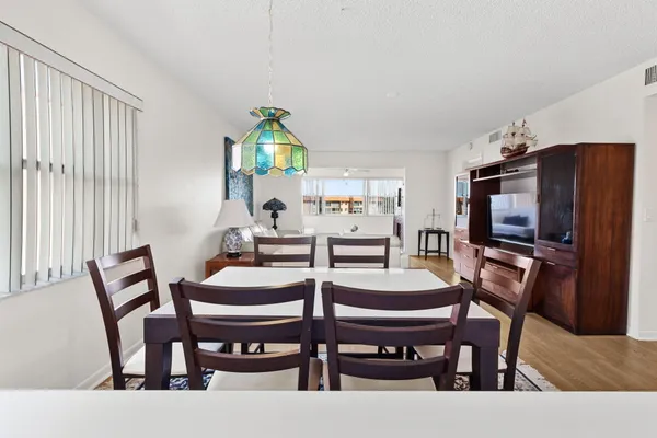 a dining room with furniture and window