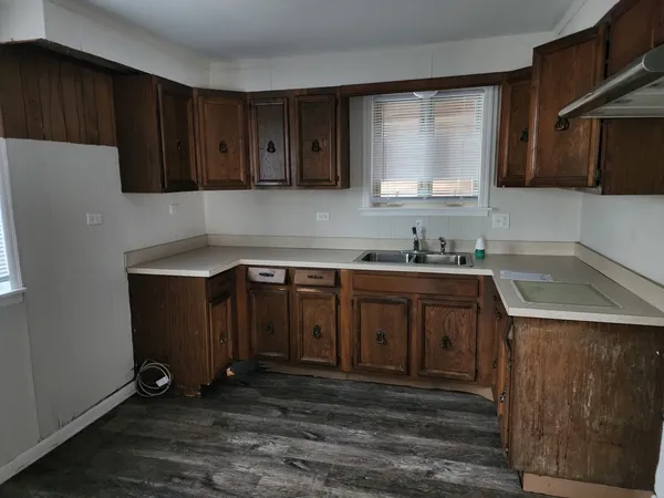 a kitchen with a sink a stove and cabinets