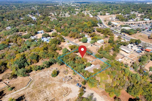 an aerial view of a houses with a yard