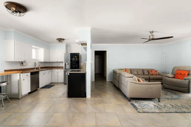 a kitchen with stainless steel appliances granite countertop a sink and a stove
