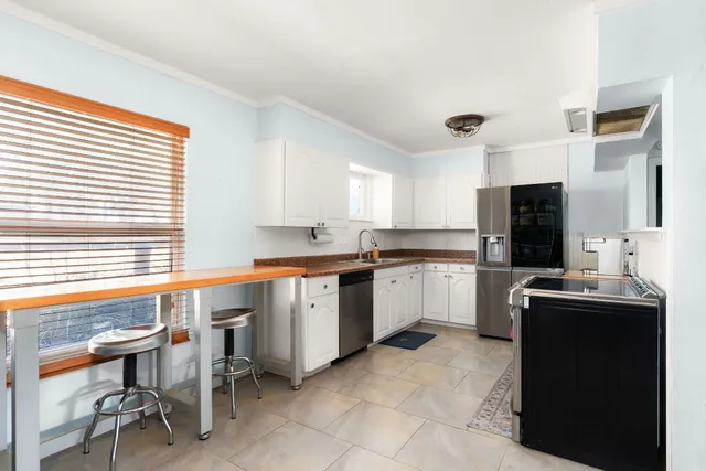 a living room with furniture and kitchen
