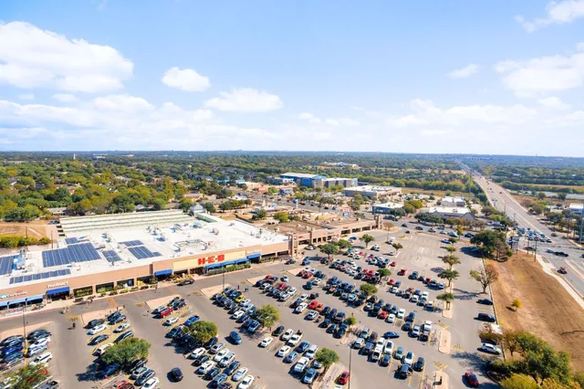 an aerial view of residential building and car parked