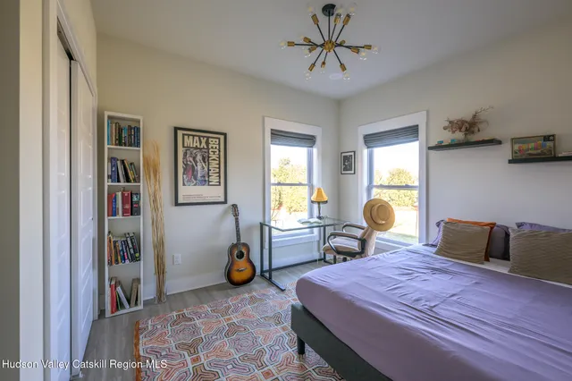 a bedroom with furniture and a window