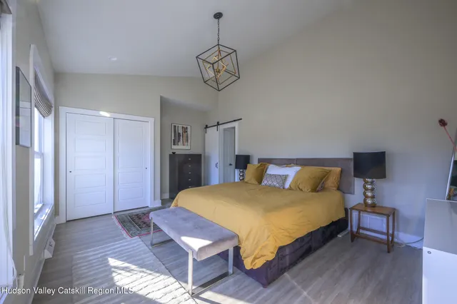 a bedroom with a bed a table and chair