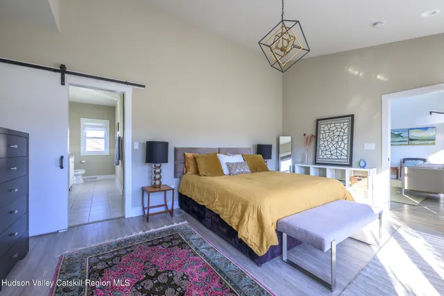 a bedroom with a bed a table and chair