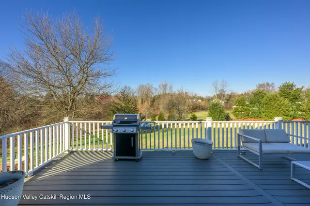a view of a roof deck with wooden floor and fence