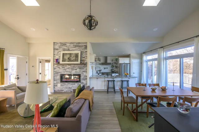 a living room with furniture fireplace and a table