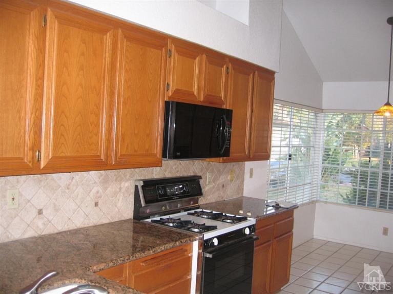 65 Valley Crest Road, Unit 74 Simi Valley, CA 93065 - Photo 6 of 25 a kitchen with stainless steel appliances a stove a sink and a microwave