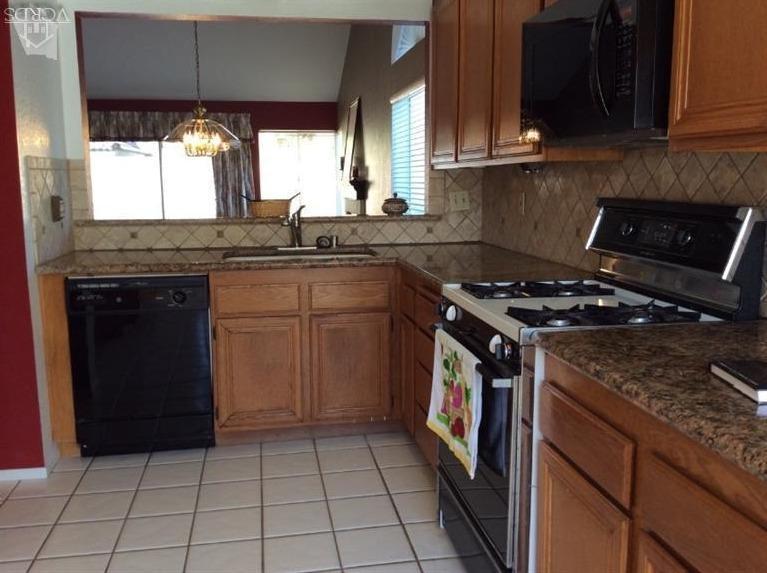 65 Valley Crest Road, Unit 74 Simi Valley, CA 93065 - Photo 8 of 25 a kitchen with a sink a stove and a microwave oven
