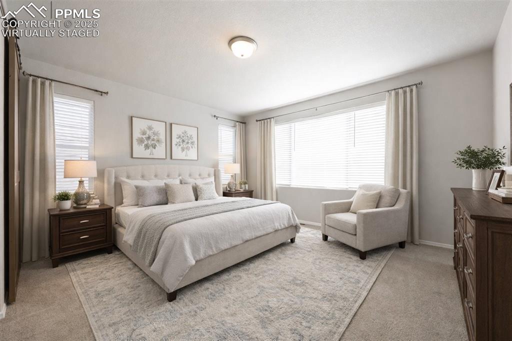 9962 Hidden Ranch Court Peyton, CO 80831 - Photo 13 of 48 a bedroom with a bed and a couch