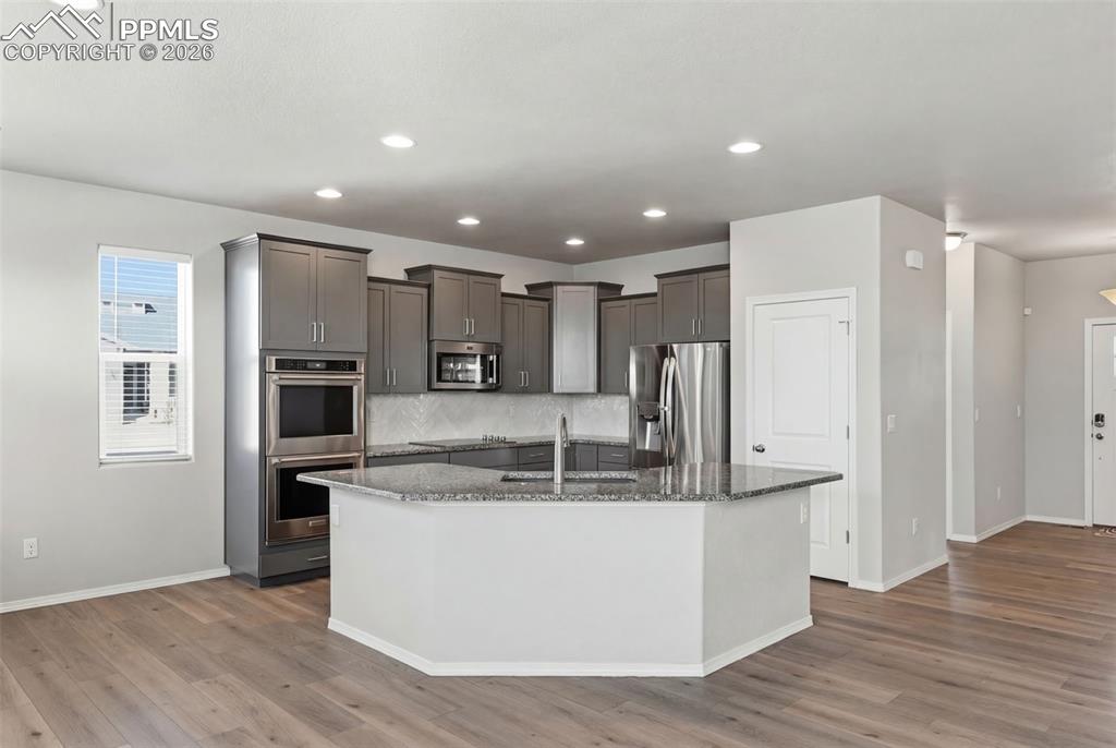 9962 Hidden Ranch Court Peyton, CO 80831 - Photo 7 of 48 a view of kitchen with stainless steel appliances granite countertop cabinets and wooden floor