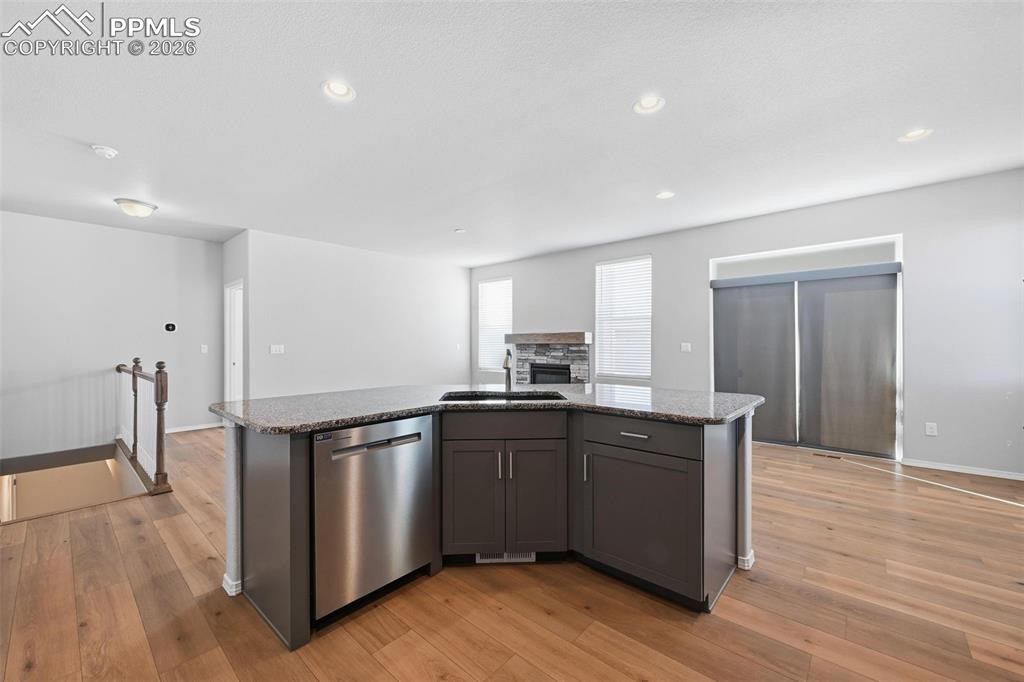 9962 Hidden Ranch Court Peyton, CO 80831 - Photo 9 of 48 a kitchen with stainless steel appliances granite countertop a sink and wooden floor