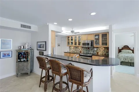 a dining area with granite countertop a table and chairs