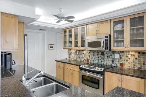 a kitchen that has a sink and a stove