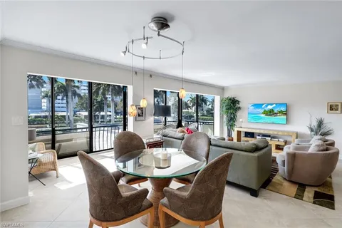 a living room with fireplace furniture and a large window