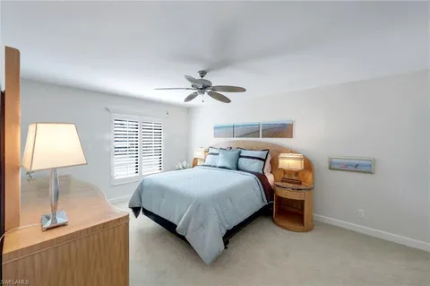 a bedroom with a bed and a lamp