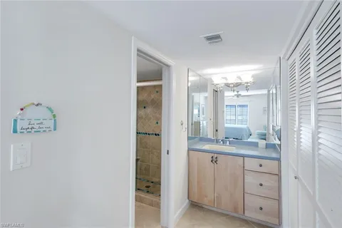 a bathroom with a granite countertop sink mirror and