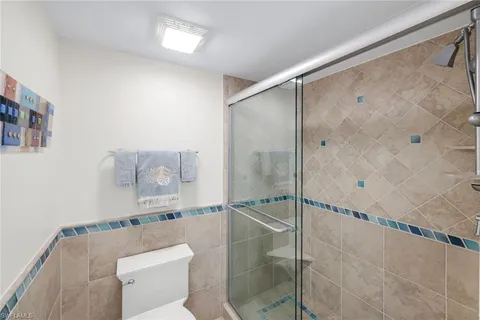 a bathroom with a shower and a toilet