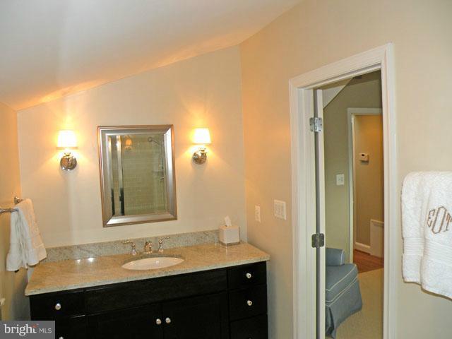 2700 Ridge Rd Drive Alexandria, VA 22302 - Photo 22 of 30 a bathroom with a granite countertop sink and a mirror