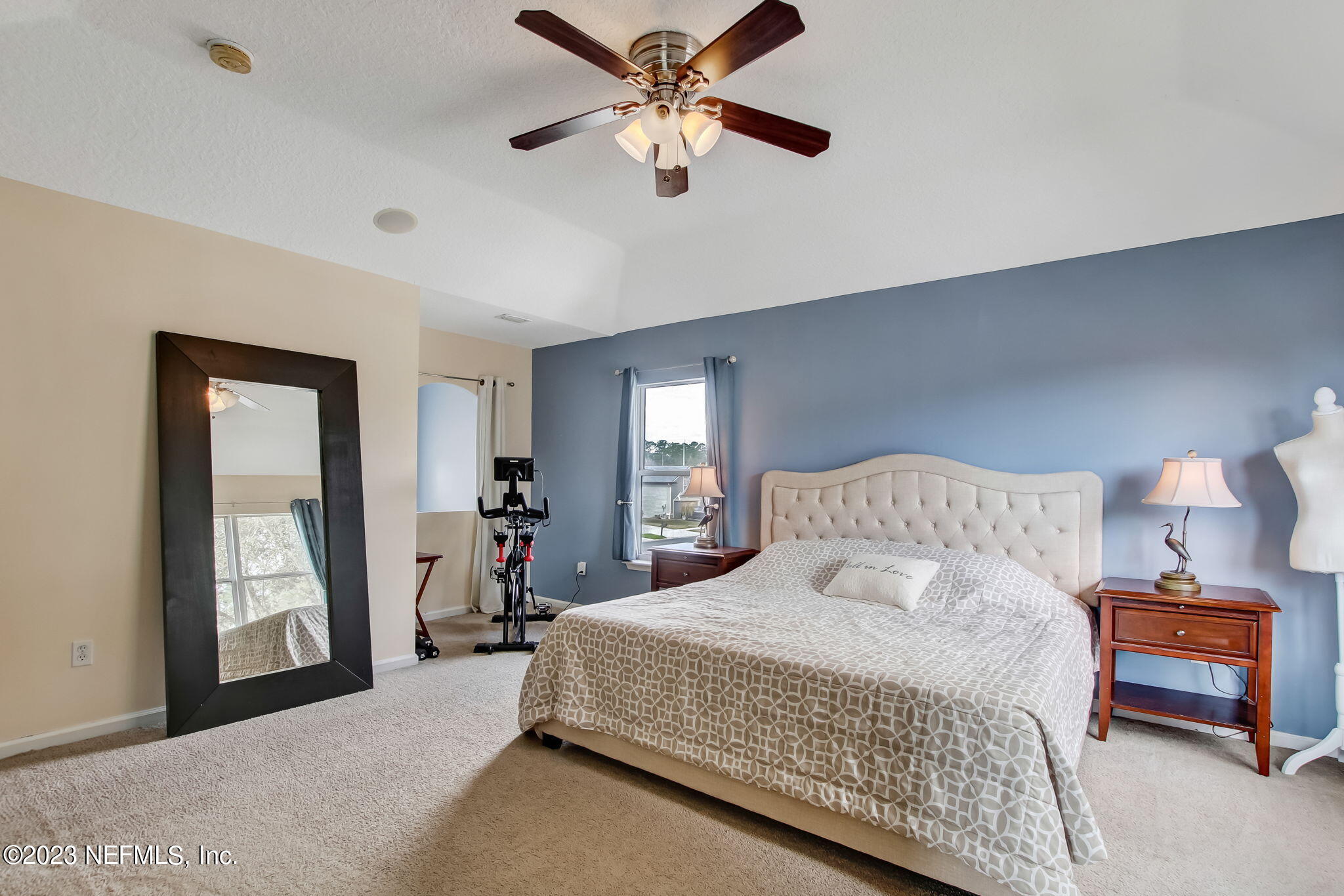 96054 Ridgewood Circle Fernandina Beach, FL 32034 - Photo 16 of 32 a bedroom with a bed and a chandelier