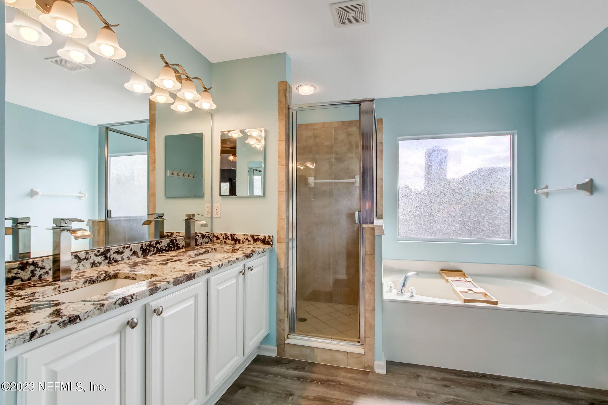 96054 Ridgewood Circle Fernandina Beach, FL 32034 - Photo 17 of 32 a bathroom with a granite countertop sink mirror and a bathtub