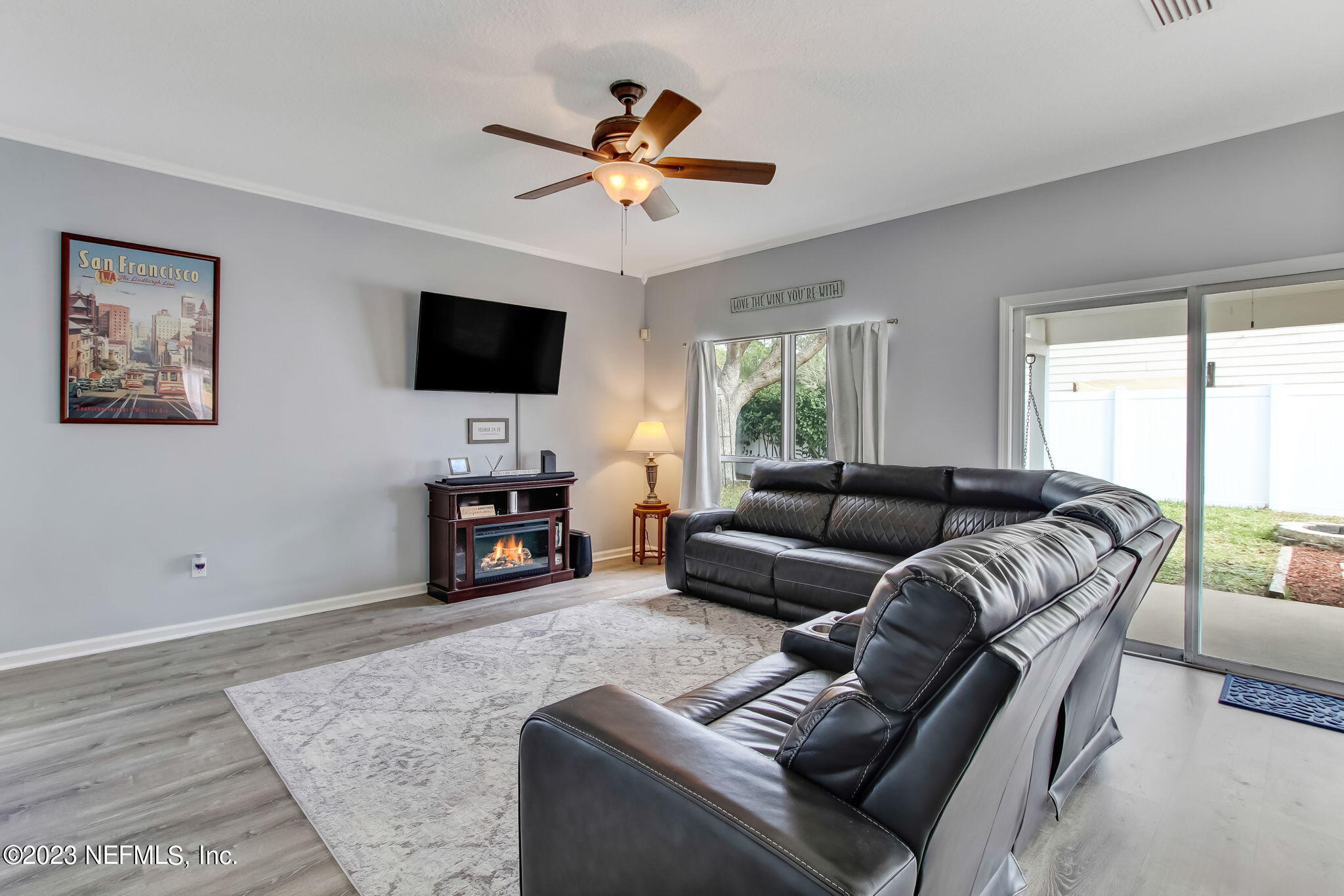 96054 Ridgewood Circle Fernandina Beach, FL 32034 - Photo 6 of 32 a living room with furniture and a flat screen tv