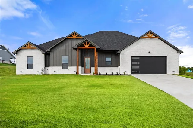 a front view of house with yard and green space